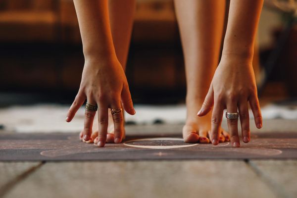 Close-up on feet positioned on a yoga mat, symbolizing balance and grounding.